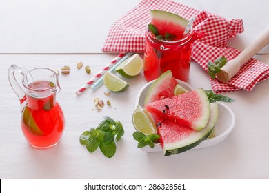 Fresh watermelon with juice and pistachio.   Watermelon fruit drink with pistachio, mint, lime and  fresh watermelon slice in heart shape bowl. .Macro, selective focus, natural light 