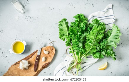 Fresh Wet Raw Green Kale Leaves Bunch. Kitchen Counter Cooking Scenery Captured From Above (top View, Flat Lay). Grey Stone As Background. Layout With Free Copy Space. Superfood And Healthy Diet.