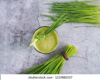 Fresh Wheat Grass Juice And Wheatgrass Plant For Health On Top View. Nutrition Food.