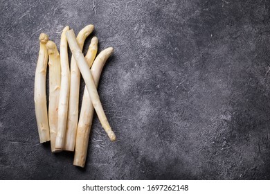Fresh, white asparagus against a dark background. Healthy eating concept. Food for vegetarians. Raw vegetable. Vitamins. Organic Asparagus .Copy space.