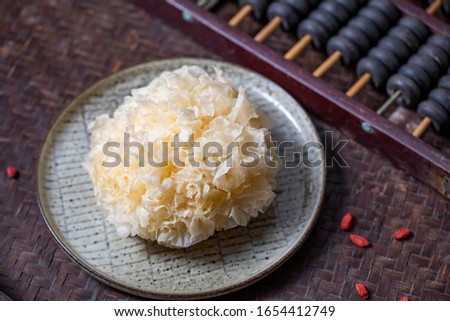 Fresh white fungus  (Tremella fuciformis)  on a bamboo background