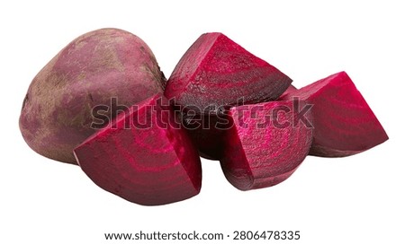 Fresh whole beetroot and several chopped wedges of raw red beet