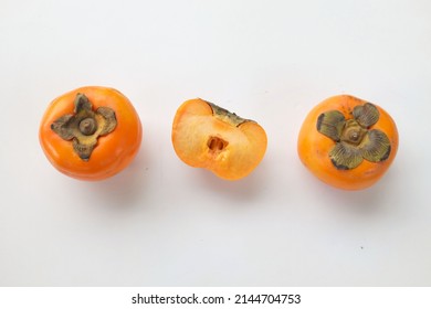 Fresh Whole, Half And Sliced Persimmon Fruit Isolated On White Background, Overhead View