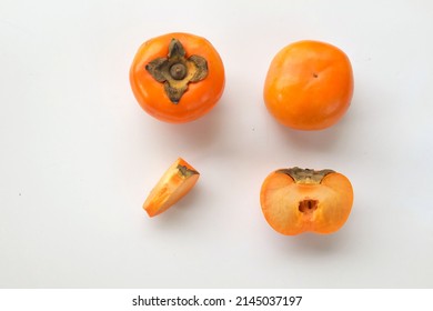 Fresh Whole, Half And Sliced Persimmon Fruit Isolated On White Background, Overhead View