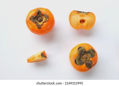 Fresh Whole, Half And Sliced Persimmon Fruit Isolated On White Background, Overhead View