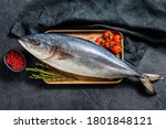 Fresh whole Japanese amberjack. Raw Fish Yellowtail. Black background. Top view