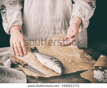 Similar – fresh whole sea bass fish on a black board