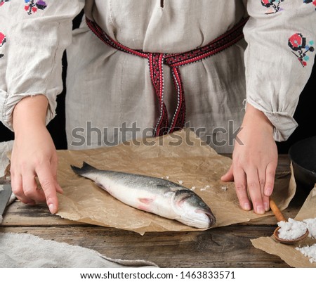 Similar – fresh whole sea bass fish on a black board