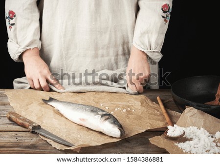 Similar – fresh whole sea bass fish on a black board