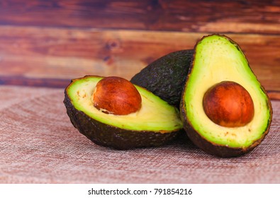 Fresh whole and sliced avocado on a table