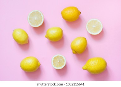 Fresh Whole And Sliced Lemon On Punchy Pink Background. Flat Lay.