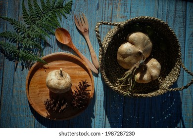 Fresh yam or sweet potato on a blue painted wooden background. Jicama can be eaten raw or cooked.