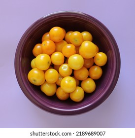 Fresh Yellow Cherry Tomatoes In A Purple Bowl