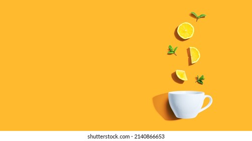 Fresh Yellow Lemons With Tea Cup Overhead View - Flat Lay