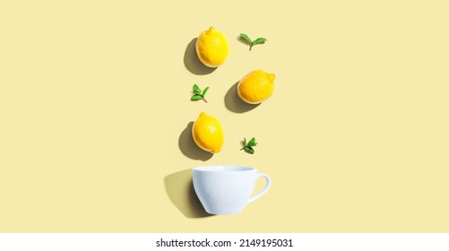 Fresh Yellow Lemons With Tea Cup Overhead View - Flat Lay