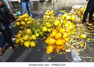 Fresh yellow, orange and green coconuts on sale on a friday market at St George's on the caribbean island of Grenada