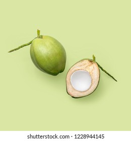 Fresh young coconuts on a green background, creative flat lay healthy food concept, top view with clipping path