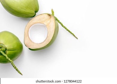 Fresh young coconuts on a white background, creative flat lay healthy food concept