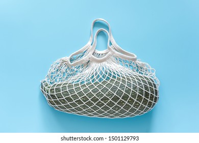 Fresh zucchini in reusable shopping eco-friendly mesh bag on blue background. Concept Organic squash vegetable and no plastic, zero waste. Copy space Top view Flat lay. - Shutterstock ID 1501129793