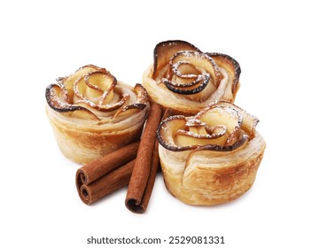 Freshly baked apple roses and cinnamon sticks isolated on white. Puff pastry - Powered by Shutterstock