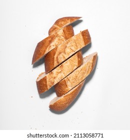 Freshly Baked Artisan Mexican Bread Cut Into Slices, Frensh Bread Roll, Top View On White Background, No People