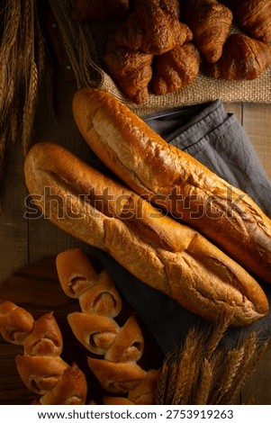 Freshly Baked Assorted Breads on Rustic Wood

A high-quality shot of various artisan breads like baguettes and croissants on a wooden surface.
Ideal for food, bakery, and culinary-themed projects.
