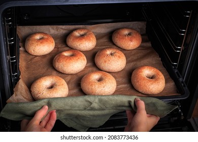 Freshly Baked Bagels. Bagels baked in hot oven. The process of making bagels.  - Powered by Shutterstock