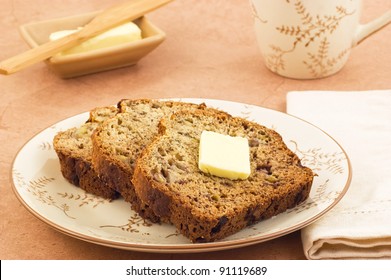 Freshly Baked Banana Bread Slices With Butter And Mug Of Tea In Horizontal Format