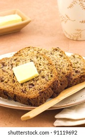 Freshly Baked Banana Bread Slices With Butter And Mug Of Tea In Vertical Format