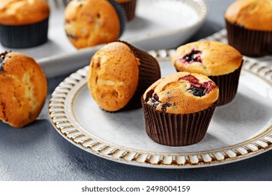 Freshly baked blueberry muffins on gray plate - Powered by Shutterstock