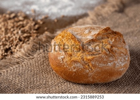 Freshly baked bread on rustic wooden background.