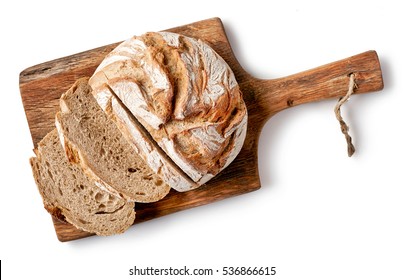 freshly baked bread on wooden cutting board isolated on white background, top view