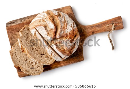 freshly baked bread on wooden cutting board isolated on white background, top view