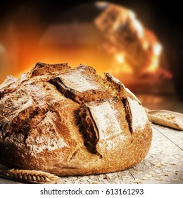 Freshly Baked Bread In Rustic Bakery With Traditional Oven. Food Background 