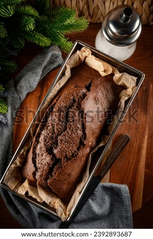 Freshly baked chocolate cake in a rectangular baking tin.