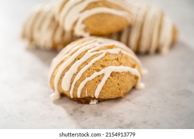 Freshly baked chocolate cookies with eggnog scones with a white chocolate drizzle on top.
