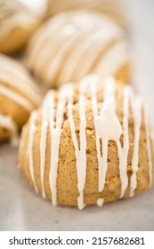 Freshly baked chocolate cookies with eggnog scones with a white chocolate drizzle on top.