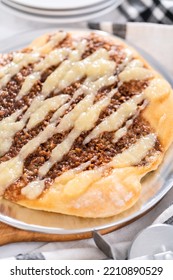 Freshly Baked Cinnamon Dessert Pizza With Cream Cheese Drizzle.