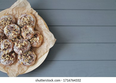 Freshly Baked Cinnamon Spices And Cocoa Rolls On Brown Parchment Paper. View From Above With Copy Space