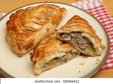 Freshly baked Cornish pasties on a plate - Shutterstock ID 183466412