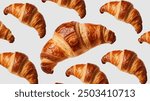 Freshly baked croissant floating in the air, isolated on a white background. French pastry croissants flying or floating.
