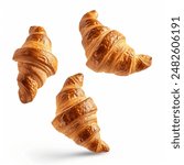 Freshly baked croissant flying in air, isolated on white background. French pastry croissants floating. Bread croissants flying in air isolated. Bakery fresh breads flying in air.