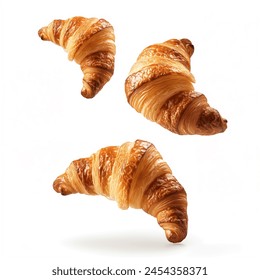 Freshly baked croissant flying in air, isolated on white background. French pastry croissants floating. Buttered bread croissants flying in air isolated.