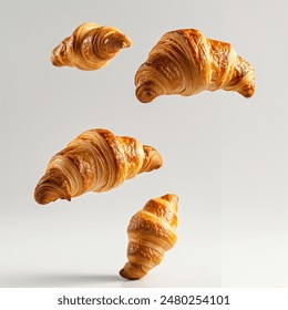 Freshly baked croissant flying in air, isolated on white background. French pastry croissants floating. Bread croissants flying in air isolated. Bakery fresh breads flying in air.
