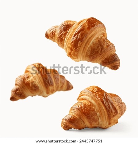 Freshly baked croissant flying in air, isolated on white background. French pastry croissants floating. Buttered bread croissants flying in air isolated. 