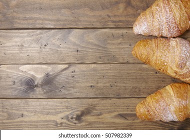 Freshly Baked Croissant Pastries On A Wooden Kitchen Counter Background Forming A Page Border