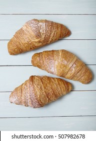 Freshly Baked Croissant Pastries On A Wooden Kitchen Counter Background