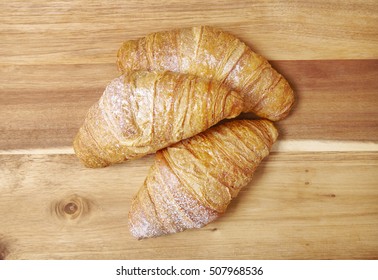 Freshly Baked Croissants Arranged On A Wooden Kitchen Counter Background 