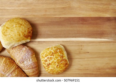 Freshly Baked Croissants And Bread Rolls Arranged On A Wooden Kitchen Counter Background Forming A Page Footer