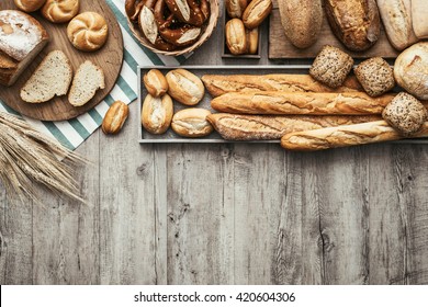 Freshly Baked Delicious Bread On A Rustic Wooden Worktop With Copy Space, Healthy Eating Concept, Flat Lay